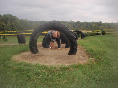 Heather Hart crawling through tires at the 2012 Hero Rush Obstacle Course Race