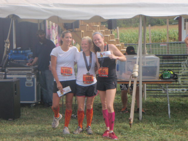 Three woman pose with their top three podium gift certificates at the finish of the 2012 Hero Rush Obstacle Course Race