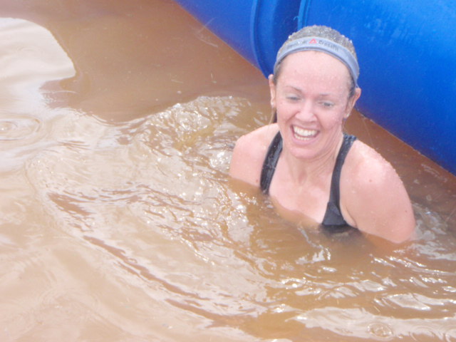 Heather Hart submerged in a pool of murky water during an obstacle at the 2012 Hero Rush Obstacle Course Race