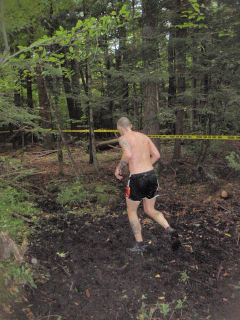 Man runs through the woods and mud during the 2012 Hero Rush Obstacle Course Race