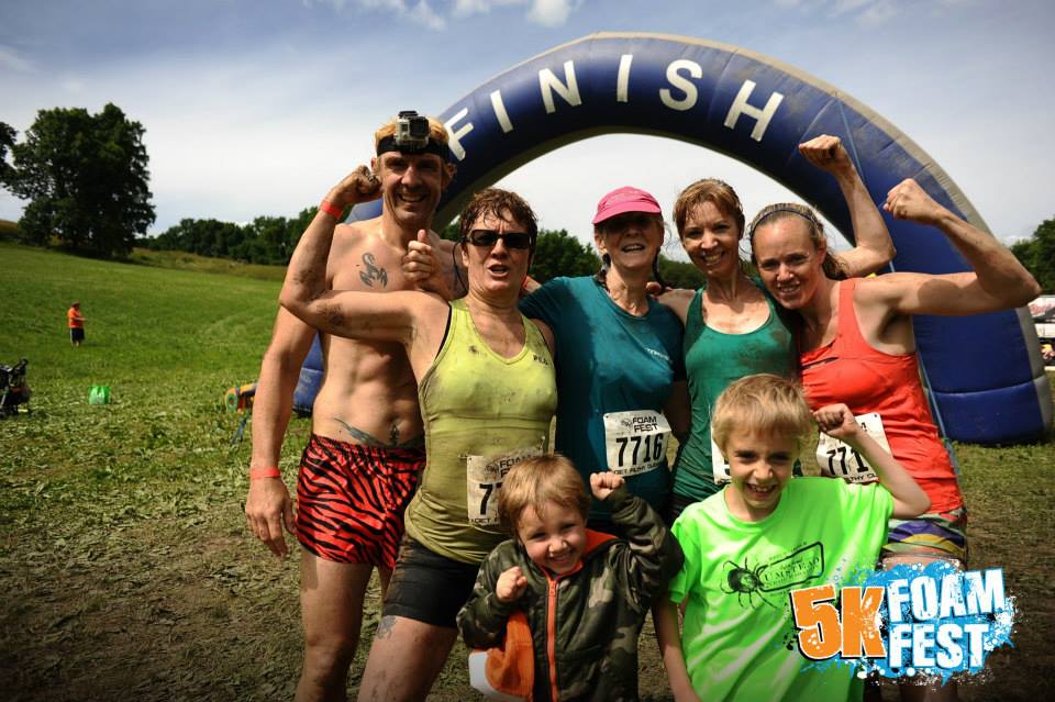 Smiling family at the finish line of the 5K Foam Fest