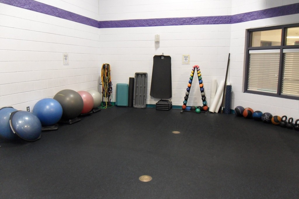 Photo of a workout area in a gym, with all of the exercise equipment neatly put away, as per appropriate gym etiquette 
