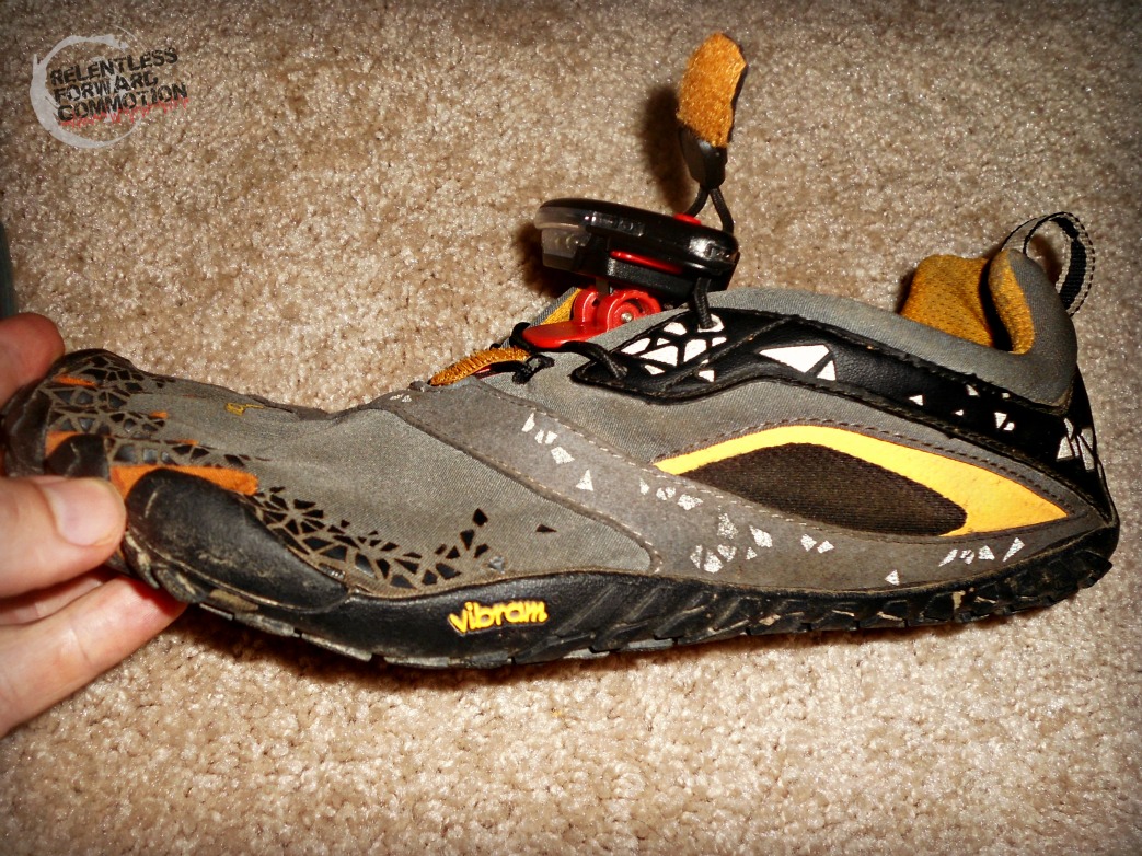 Image of the Night Runner 270 shoe light on a vibram five finger running shoe, lateral view 