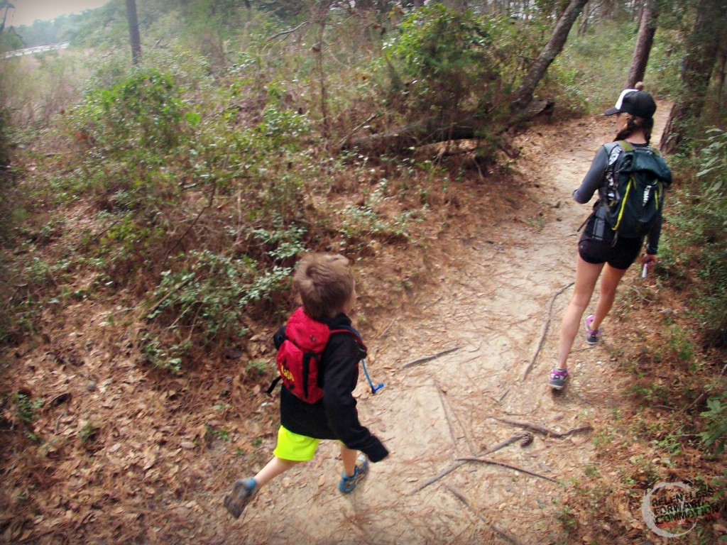 Mom and son trail running through the forest