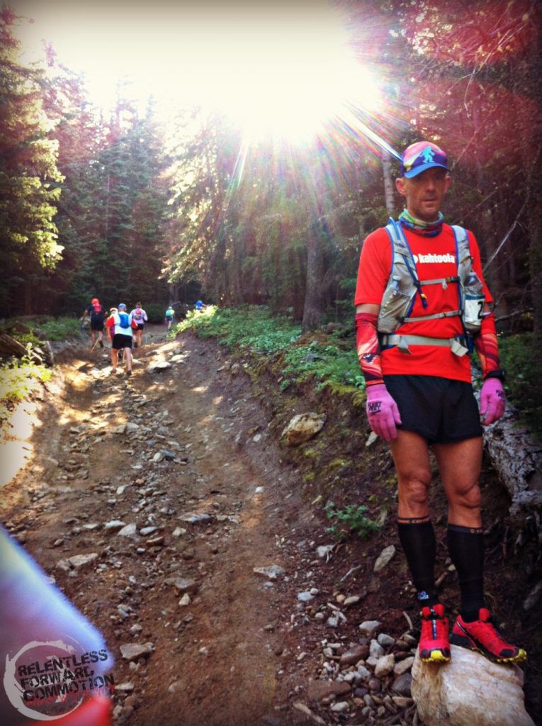 Geoffrey Hart standing on a rock on the side of a very steep trail.  Finding The Best Shoes for Ultramarathon includes analyzing what type of terrain your race will be held on .