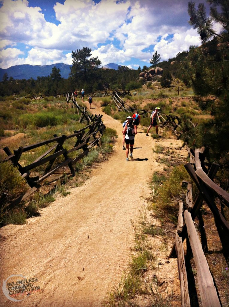 photo of many trail runners on an open, wide trail in the high desert of Colorado 