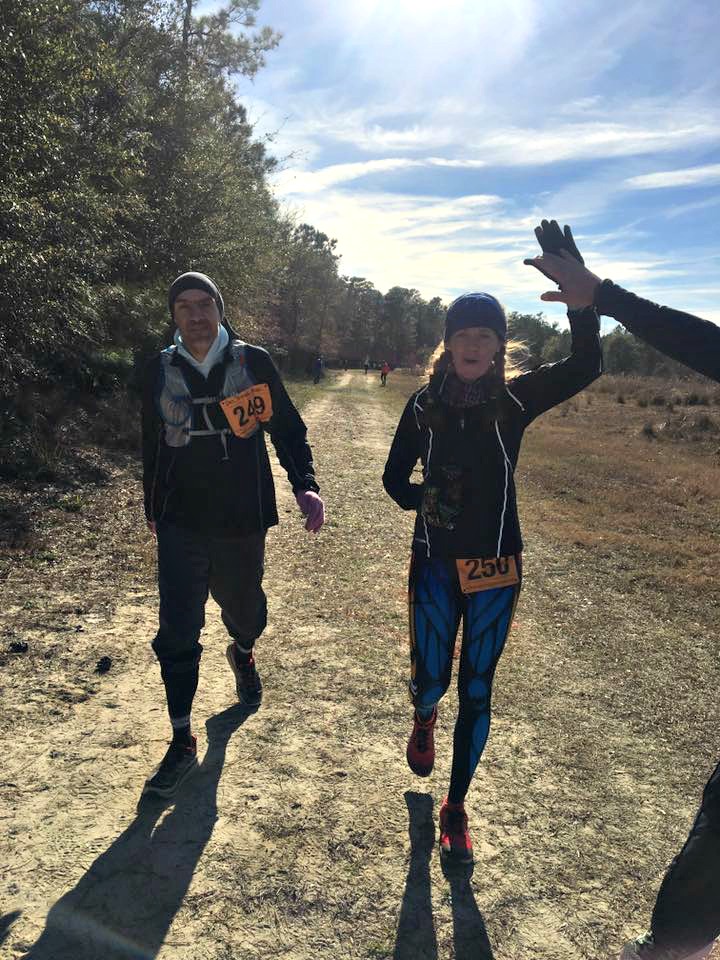 Heather and Geoff Hart getting a high five while on the course of an ultramarathon
