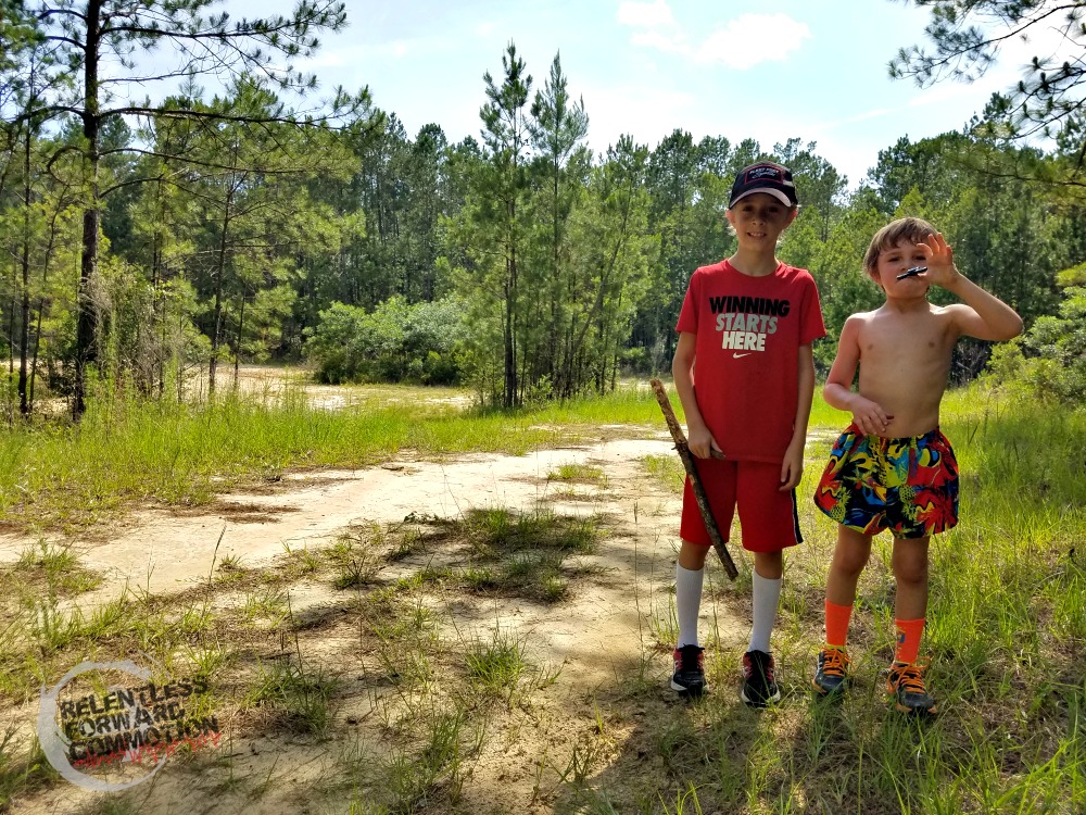 Image of two young boys in trail running clothes on a trail in the forest