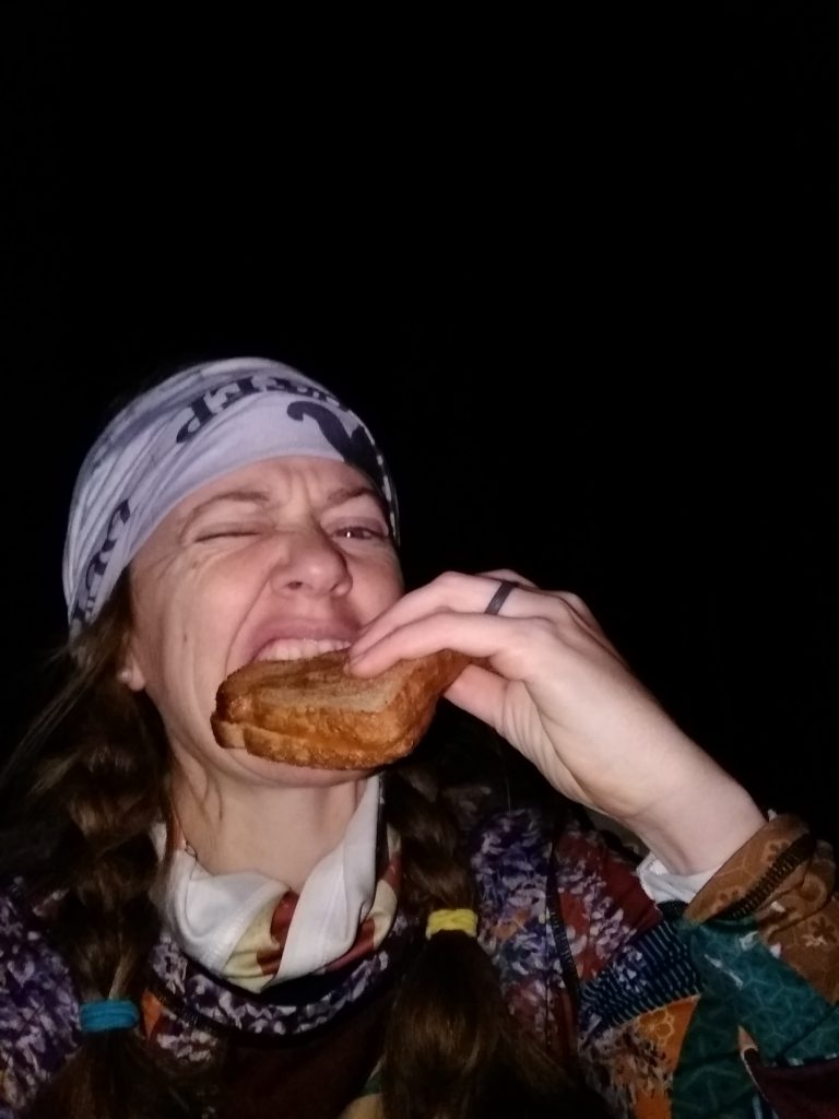 Heather Hart eating a grilled cheese mid race 