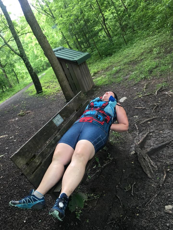 sleep during a 100 mile race. 
 Ultrarunner taking a nap on a wooden bench in the forest in the middle of an ultramarathon. 