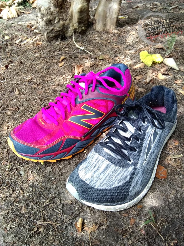 Example of a trail running shoe next to a road running shoe.