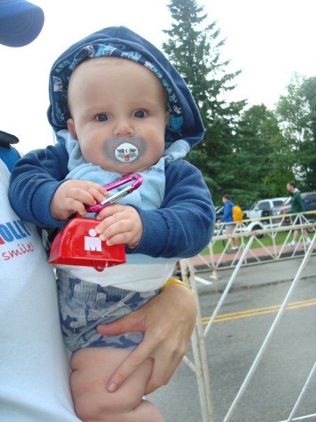 Baby holding a cowbell