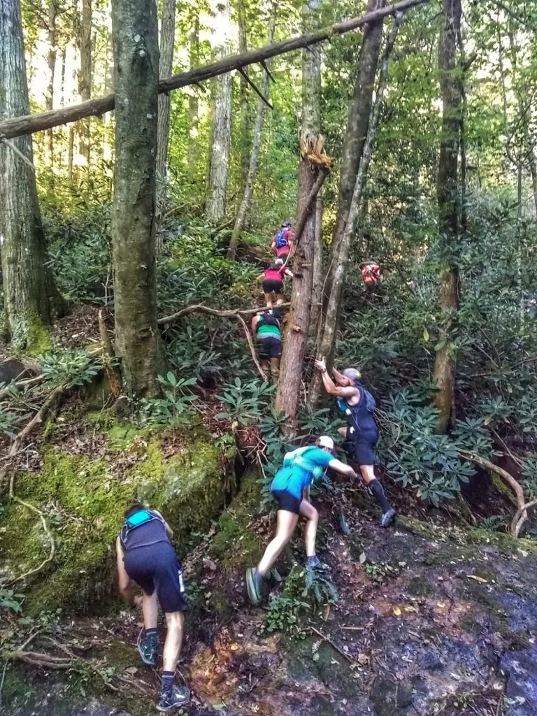 Runners scrambling up the side of a steep trail during the Table Rock 50K ultramarathon 