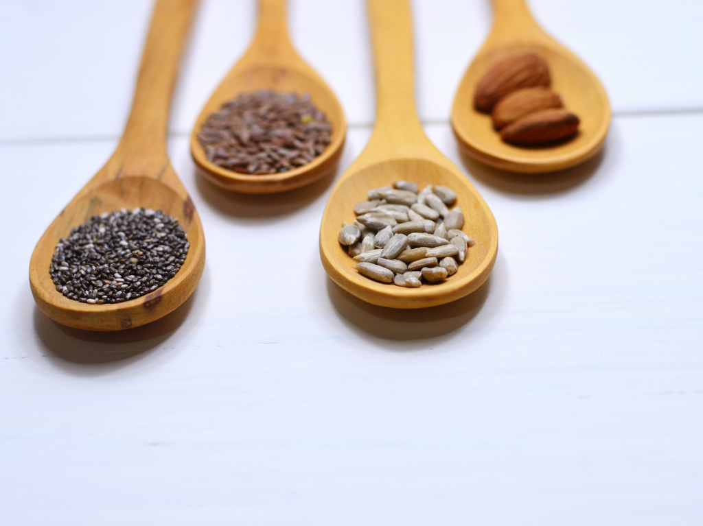 Seeds, full of omega fatty acids, on wooden spoons.  Ideal to add into your ultramarathon diet. 