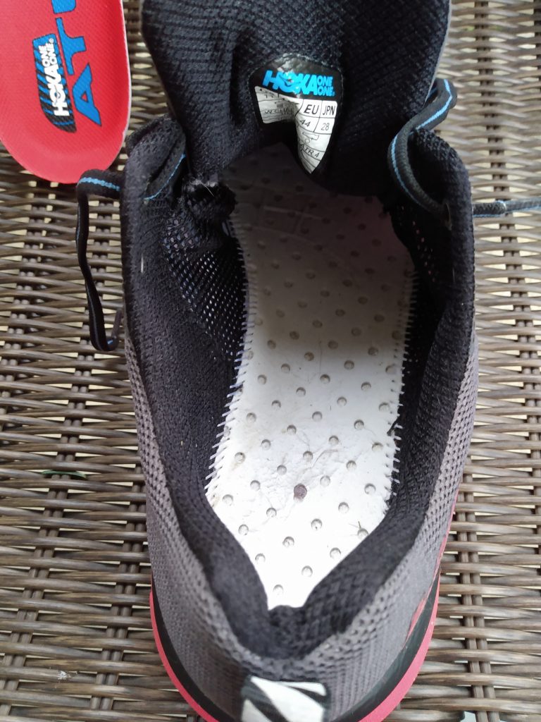 The bottom of a running shoe showing stitching underneath the sock liner