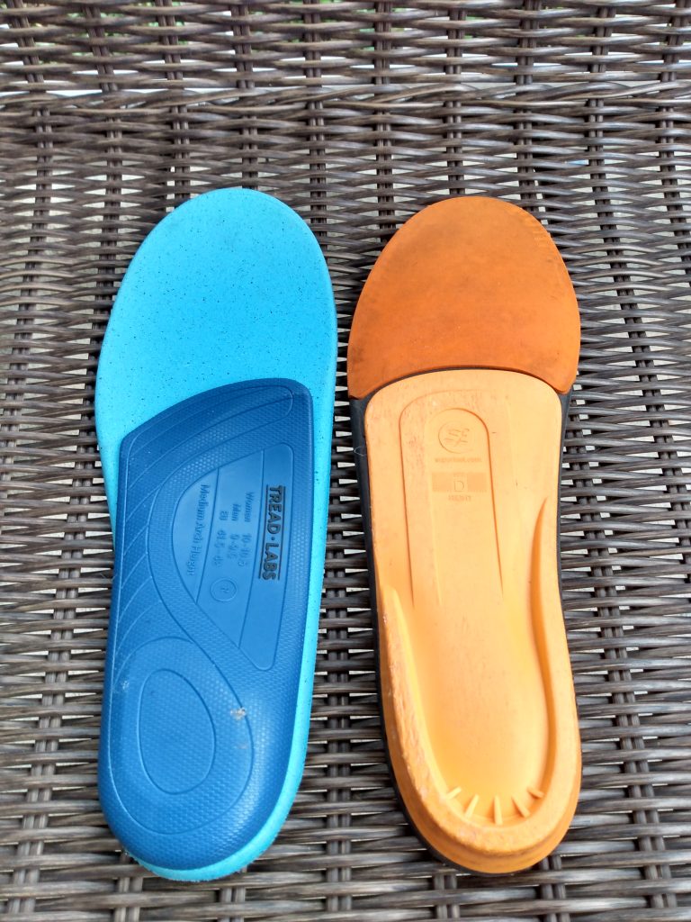 The bottom plastic molded arches of aftermarket insoles for running shoes