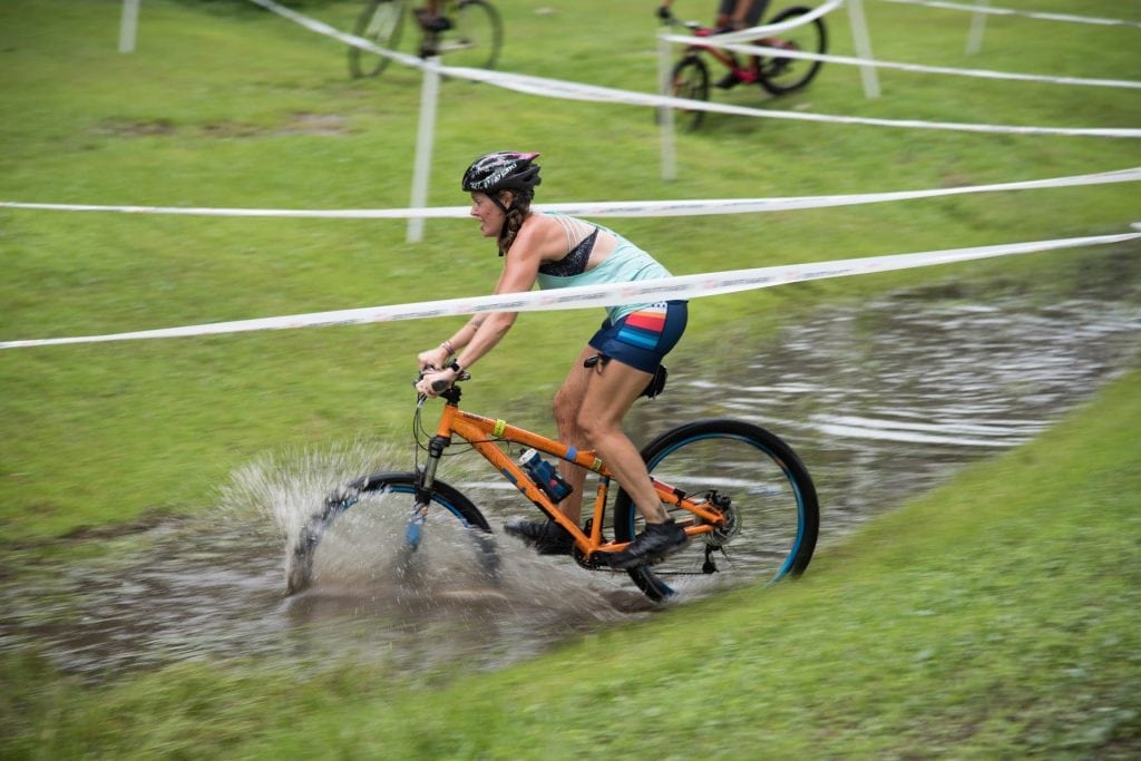 Cyclocross Heather Hart riding through puddle
