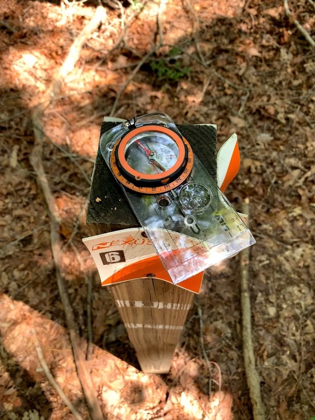 Compass on wooden post at Crowders Mountain State Park Permanent Orienteering Course