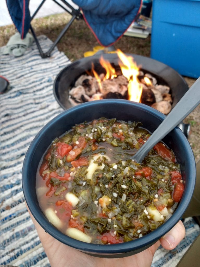 bowl of healthy soup in front of a campfire 