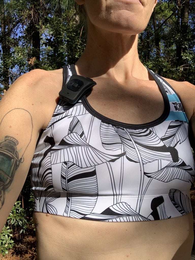 Noxgear 39 G Wearable Bluetooth Speaker clipped to a sports bra on a female runner 