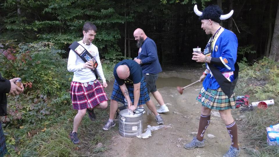 Image of Hash House Harriers during a closing circle ceremony during a Hashing trail , wearing kilts and drinking beers