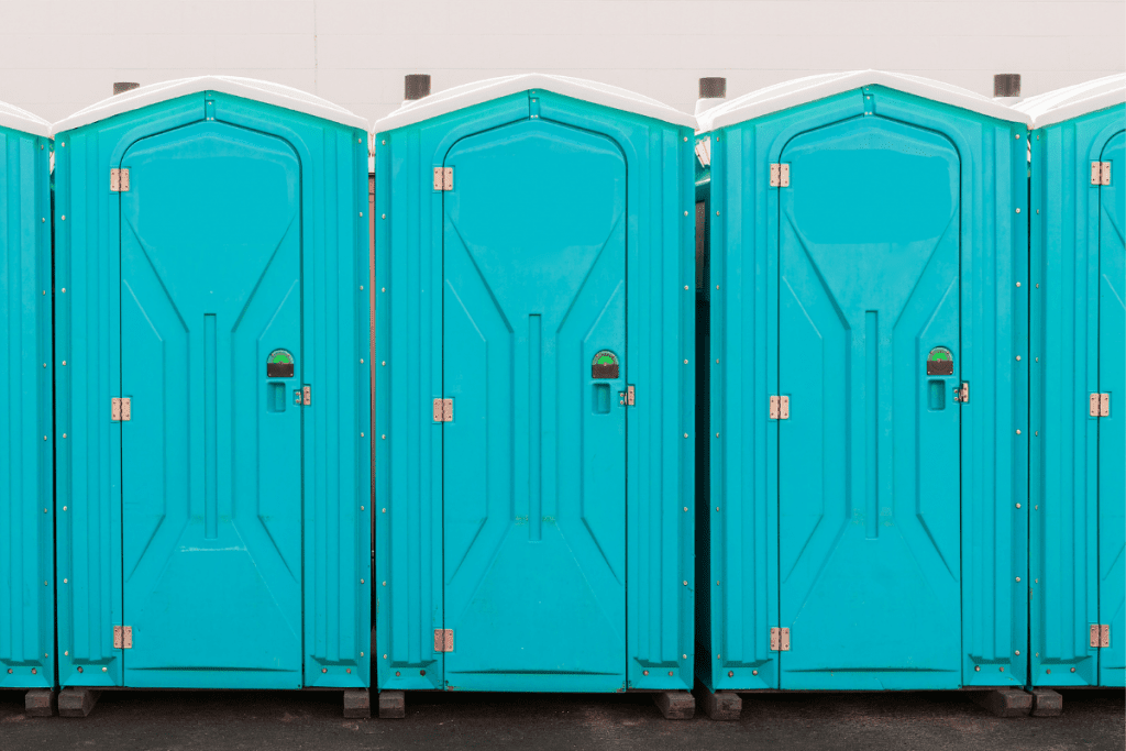 Picture of a row of blue port-a-potties. 
 Ultrarunning and Caffeine: Pre and Race Day Supplementation Strategies Explained