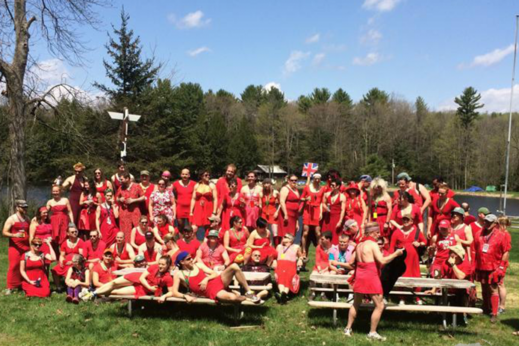 Image of a large group of Hash House Harriers wearing red dresses during an annual Red Dress Run