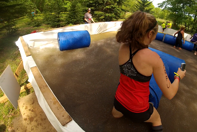 Athlete almost shorts deep in a pool of squishy, fake "hazmat gel" at the the Hero Rush OCR
