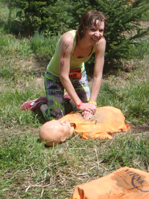 Woman gives CPR to a dummy during the the Hero Rush OCR