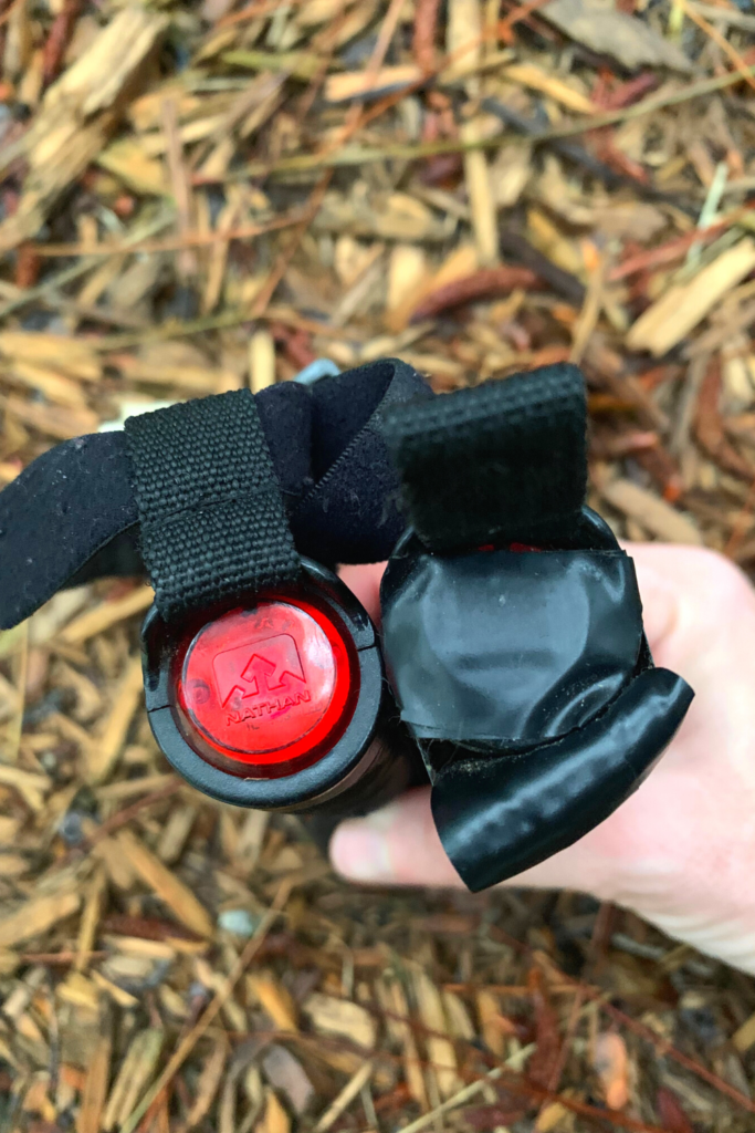 Image of the bottom of the Nathan Terra Fire Hand Torch, showing blinking red light