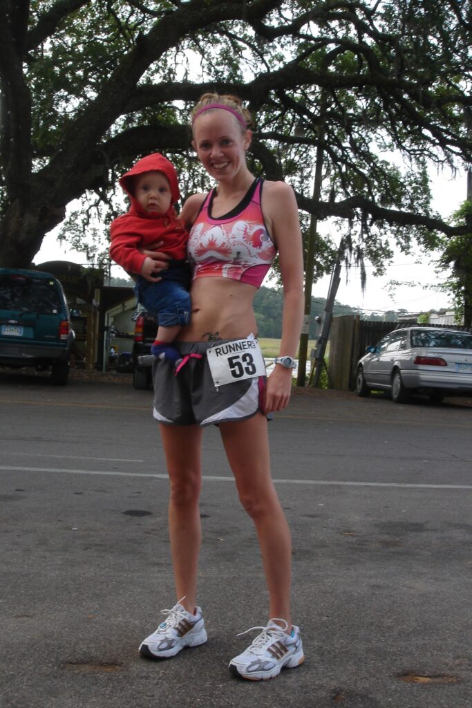 Heather Hart holding a baby after a 5K race