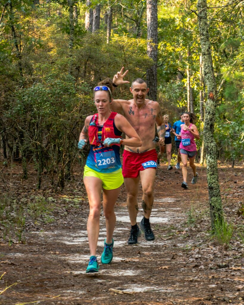 Heather and Geoff Hart running down a trail during the 2022 KFB Lynches River Adventure Race