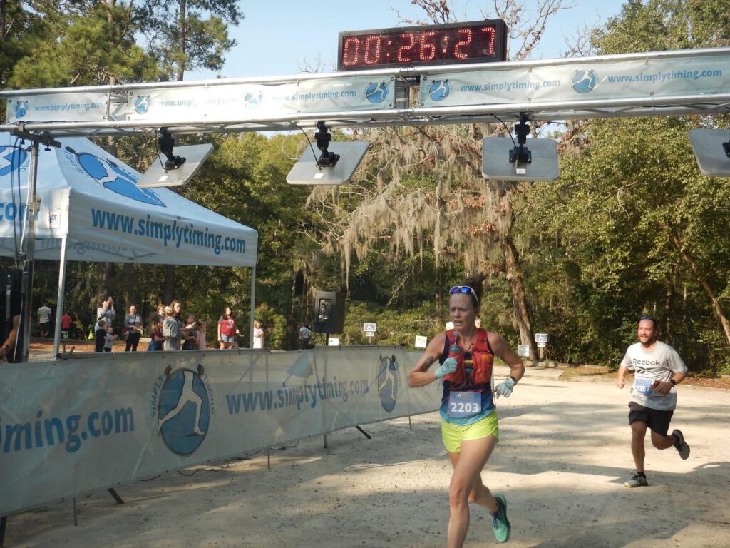 trail runner sprints to the finish line of a race