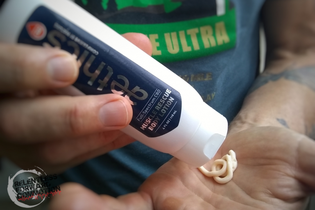 A runner squirts CBD Muscle rescue body lotion into his hand