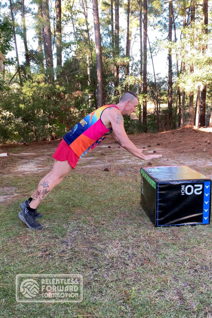 Geoffrey Hart performs a plyo box push off plyometrics for runners exercise