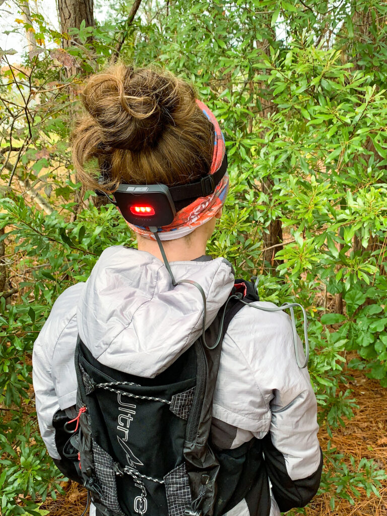 photo demonstrating the BioLite HeadLamp 800 Pro plugged into a power bank while being worn