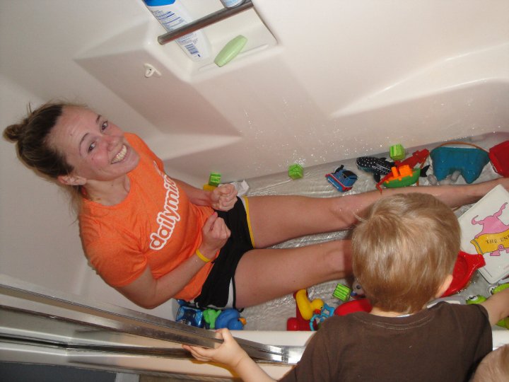 Heather Hart taking an ice bath after running surrounded by kids bathtub toys