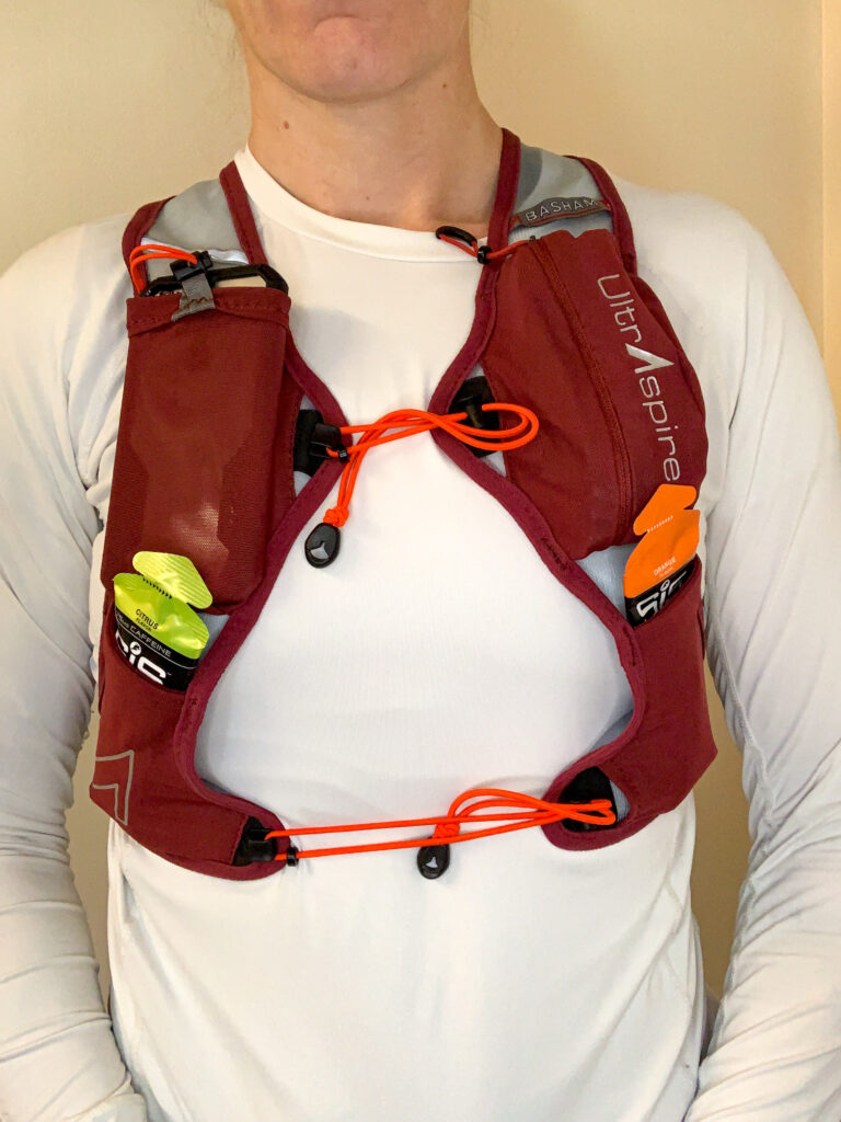 Front view of runner wearing the UltrAspire Basham Race Vest with fully loaded pockets