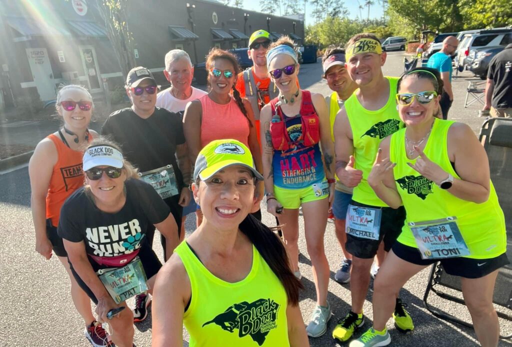 Group of runners smiling before the Black Dog Running Company ten year anniversary ultramarathon