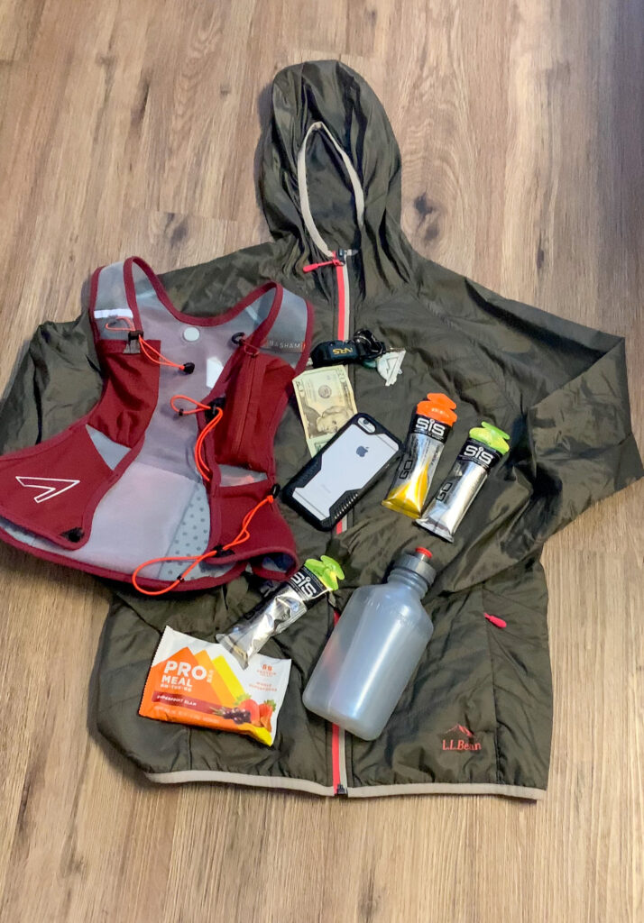 Image of the UltrAspire Basham Race Vest and various trail running gear