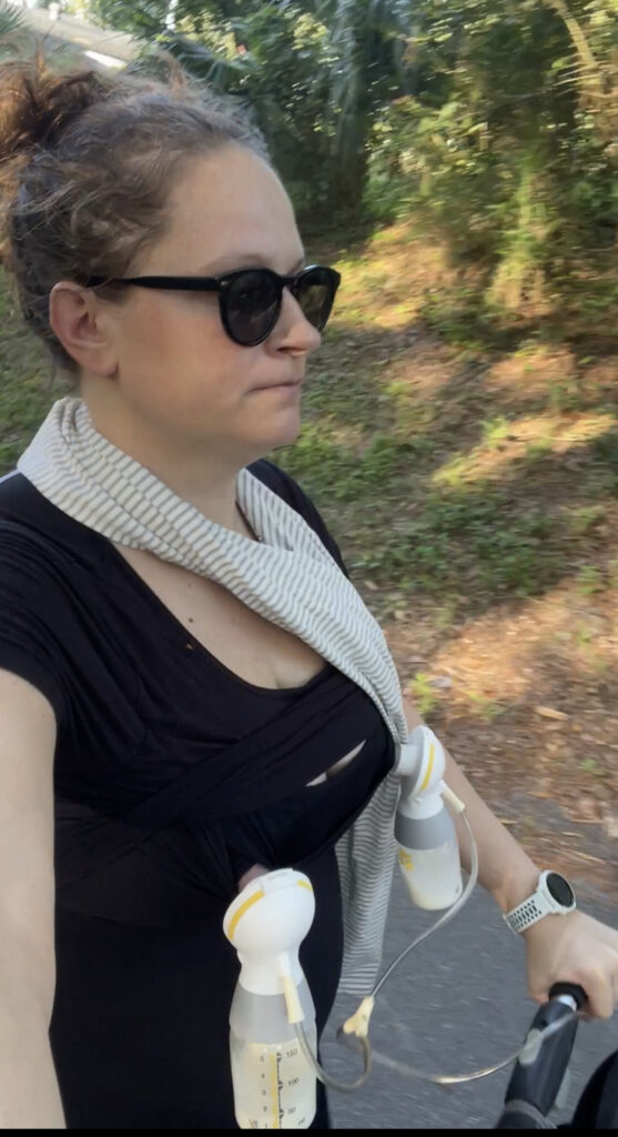Ultrarunner and Coach Maggie Seymour pushing a stroller down the road while simultaneously using a breast pump