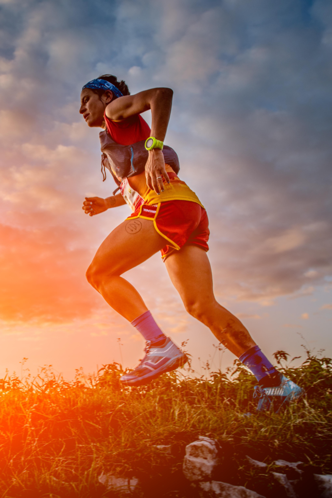 ultra runner performing stride running drills on a trail